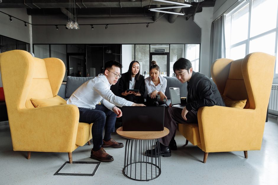 A group of colleagues engaging in a collaborative meeting in a modern office setting.