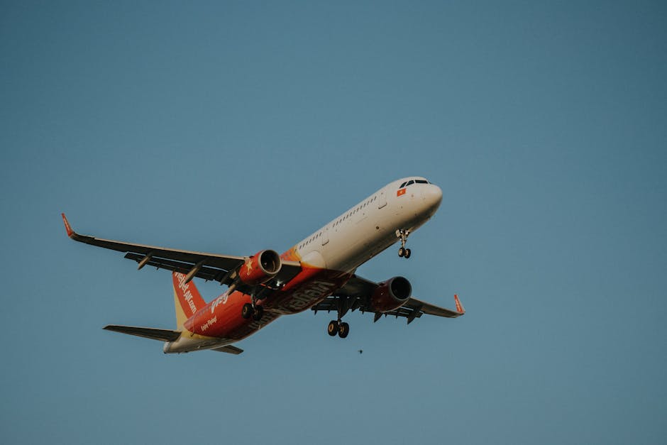 VietJet airplane soaring in clear blue sky from a low angle perspective during daytime flight.
