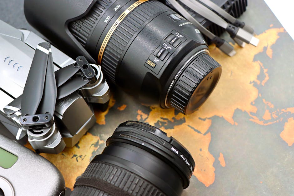 Close-up of digital camera, lenses, and drone on vintage map. Perfect for travel and media themes.