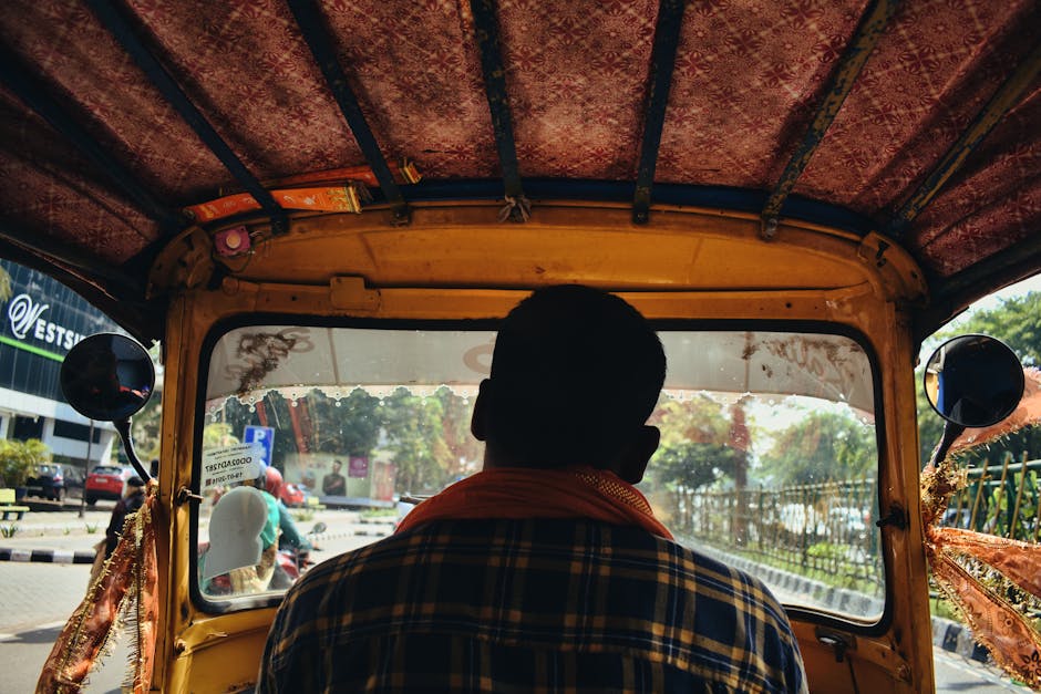 View from inside an auto rickshaw navigating city streets in Bhubaneswar, India.