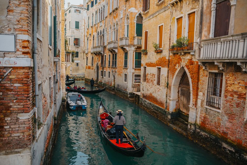 Picturesque view of a gondola on a Venetian canal surrounded by historic buildings.